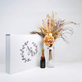 Elegant gift box featuring flowers and a bottle of champagne | NEON Packaging