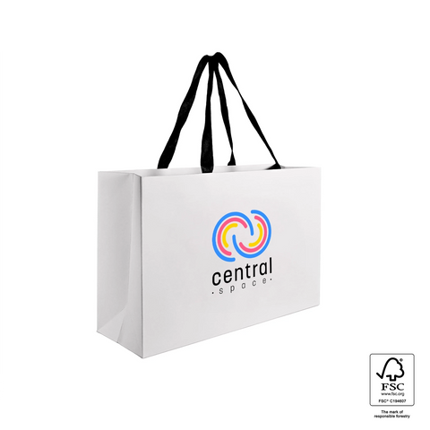 Image of White paper bag with black handles and a blue label on a white background