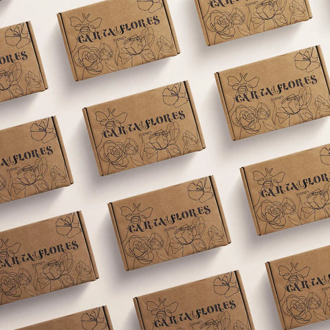 Image of Pattern of 'Gata y Flores' branded brown boxes on a white background