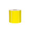 Yellow thermal labels roll on white background.