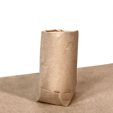 Image of Kraft brown wrapping paper wrapped around a candle product