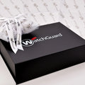 white tissue paper on top of black printed gift box | NEON packaging