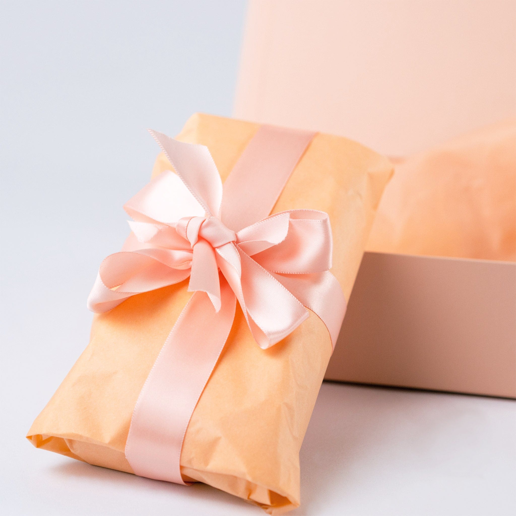 NE000183 NEON Acid-Free Tissue Paper - Peach is use for gift wrapping with satin ribbon.
